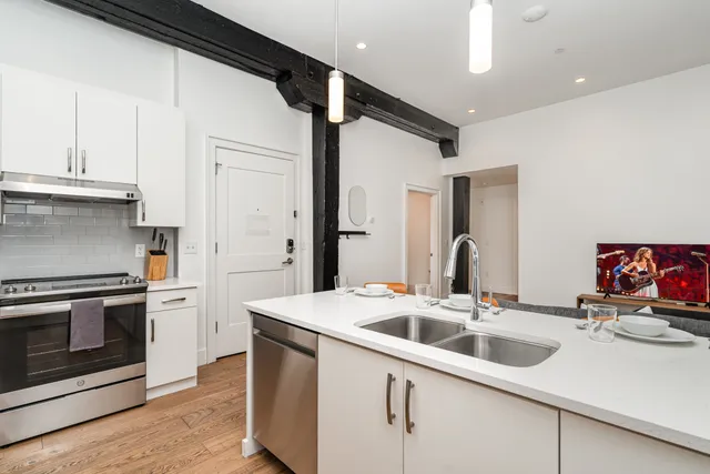 a kitchen with stainless steel appliances kitchen island a sink stove and refrigerator