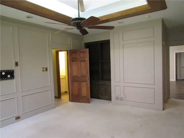 a view of a livingroom with a ceiling fan a fireplace and wooden floor