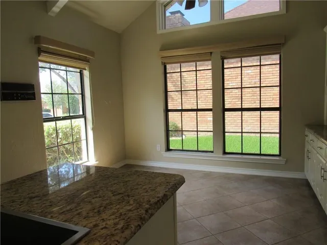 a view of a room with wooden floor and chandelier