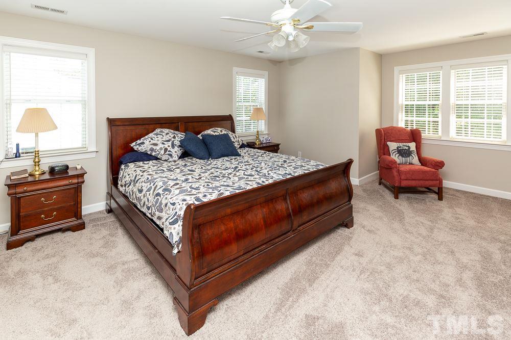 5116 Bartons Enclave Lane Raleigh, NC 27613 - Photo 15 of 30 a bedroom with a bed and wooden floor