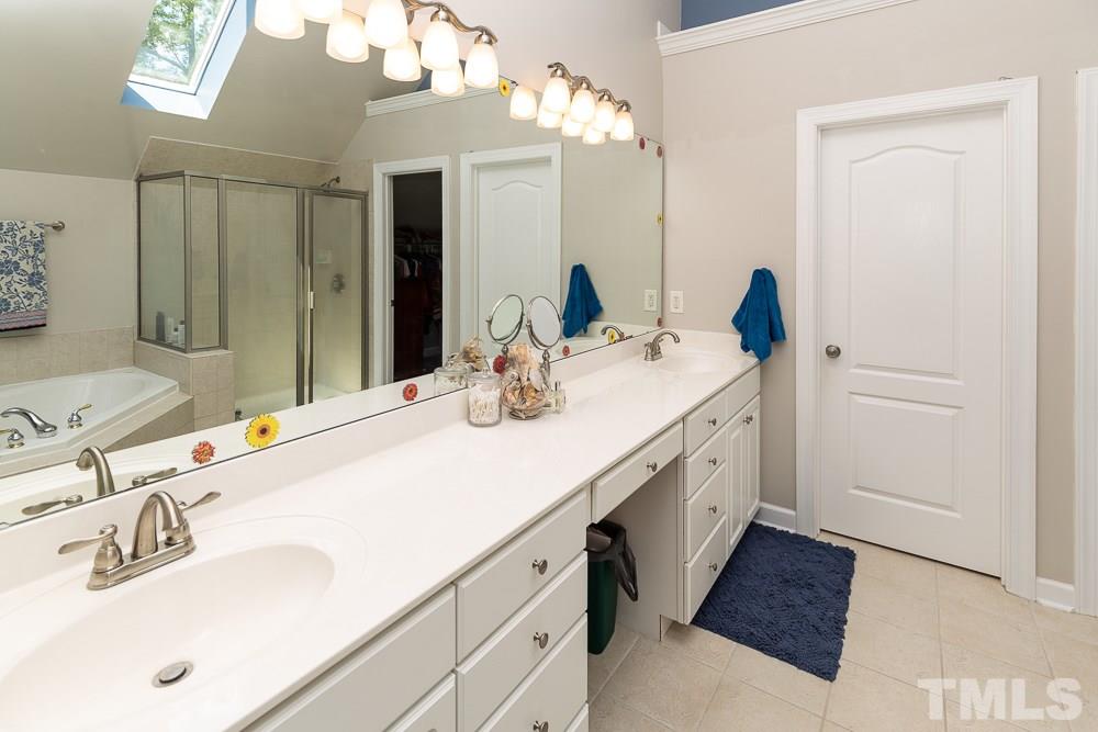 5116 Bartons Enclave Lane Raleigh, NC 27613 - Photo 17 of 30 a bathroom with a sink and a mirror