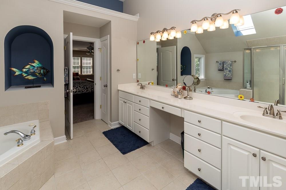 5116 Bartons Enclave Lane Raleigh, NC 27613 - Photo 18 of 30 a spacious en suite bathroom with a double vanity sink and a mirror