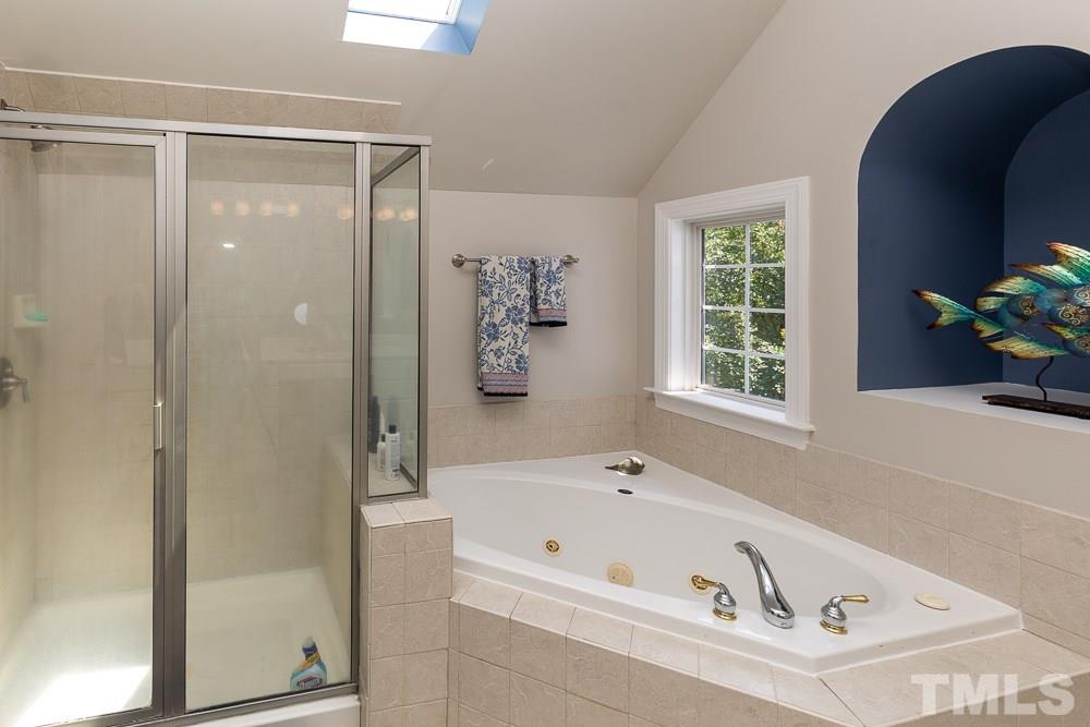 5116 Bartons Enclave Lane Raleigh, NC 27613 - Photo 19 of 30 a bathroom with a bathtub and a shower