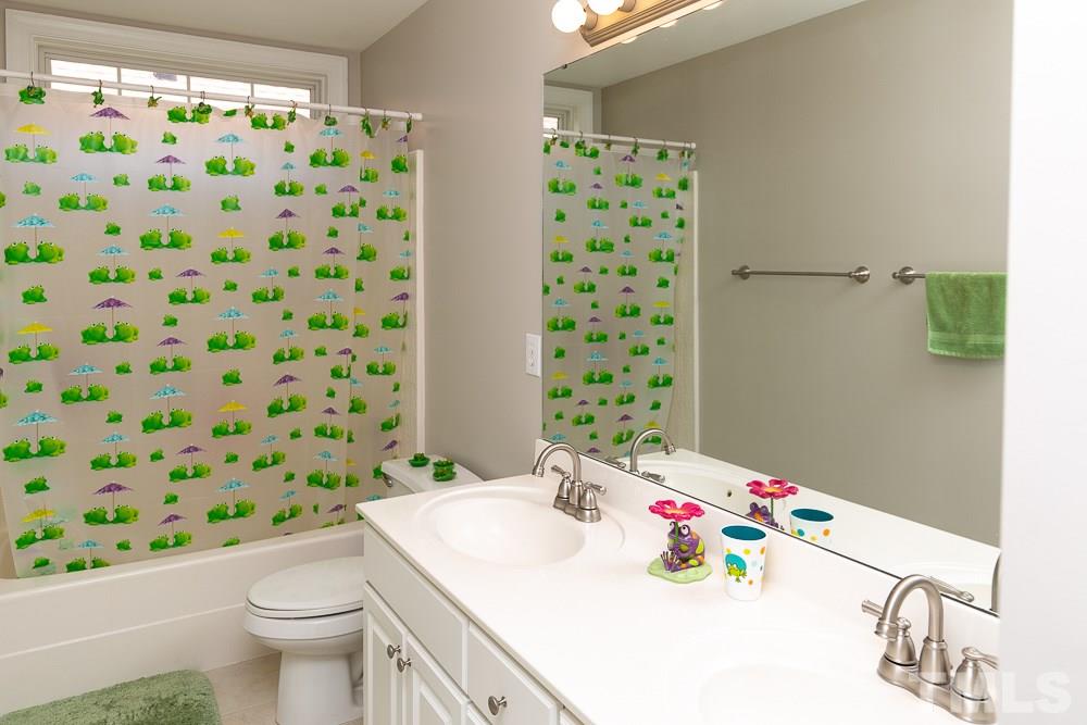 5116 Bartons Enclave Lane Raleigh, NC 27613 - Photo 21 of 30 a bathroom with a sink toilet and shower