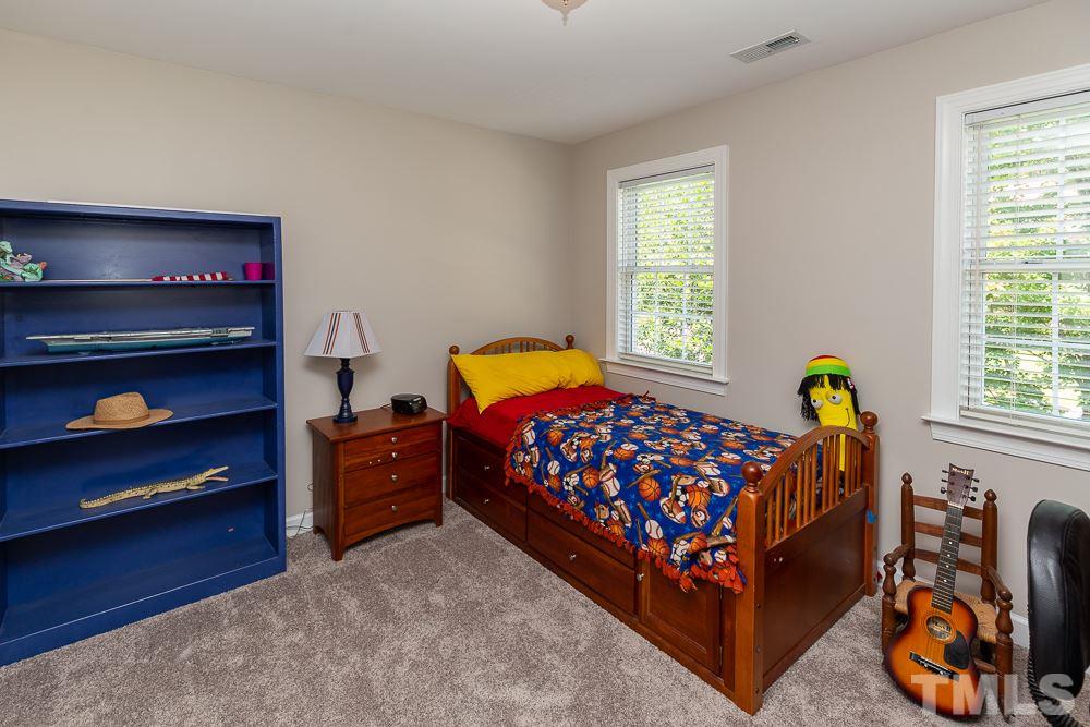 5116 Bartons Enclave Lane Raleigh, NC 27613 - Photo 22 of 30 a bedroom with a bed and a window