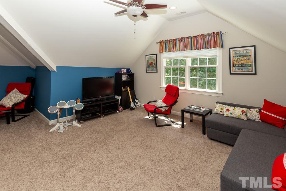 5116 Bartons Enclave Lane Raleigh, NC 27613 - Photo 24 of 30 a living room with furniture a flat screen tv and a window