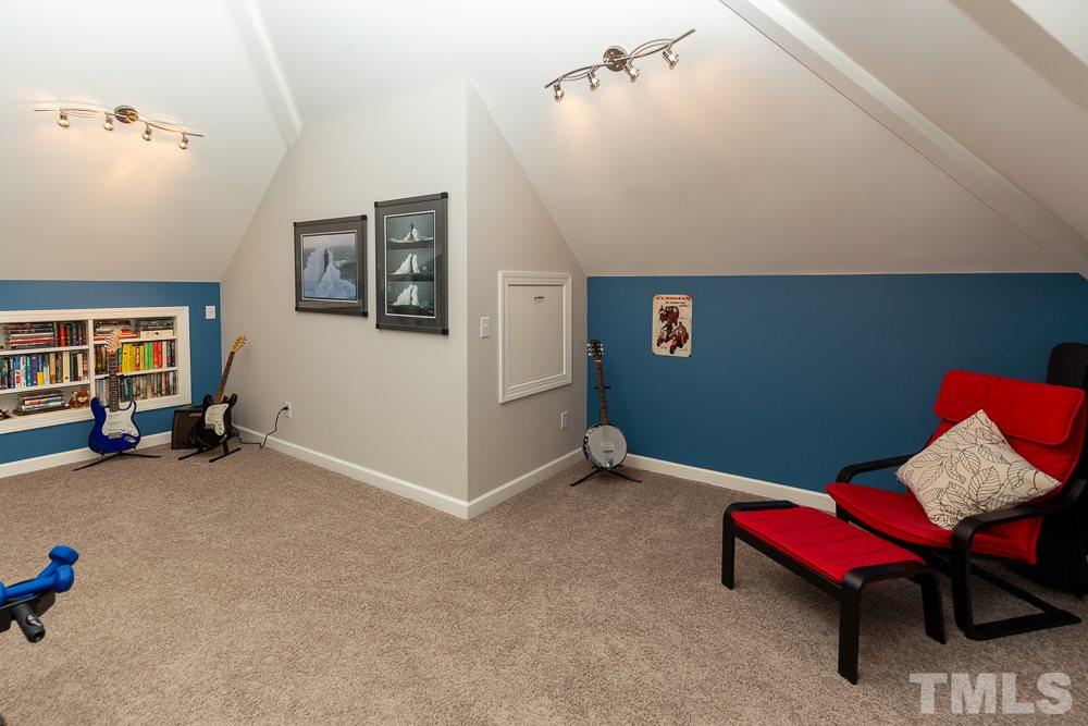 5116 Bartons Enclave Lane Raleigh, NC 27613 - Photo 25 of 30 a living room with furniture and a baby crib