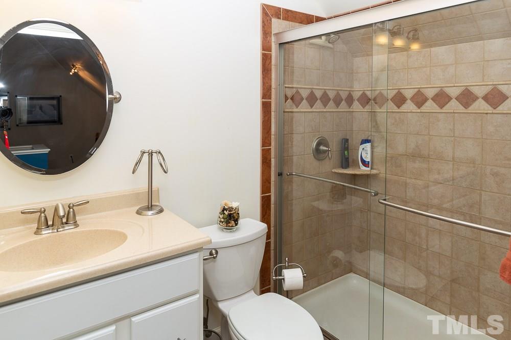 5116 Bartons Enclave Lane Raleigh, NC 27613 - Photo 26 of 30 a bathroom with a sink toilet and shower