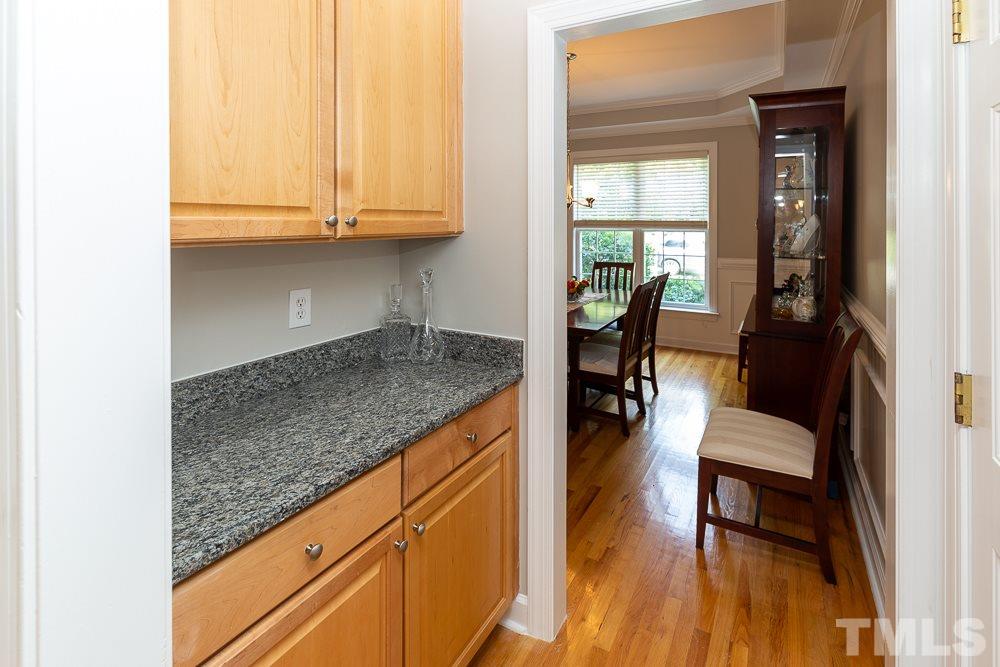 5116 Bartons Enclave Lane Raleigh, NC 27613 - Photo 8 of 30 a view of kitchen island with furniture and wooden floor