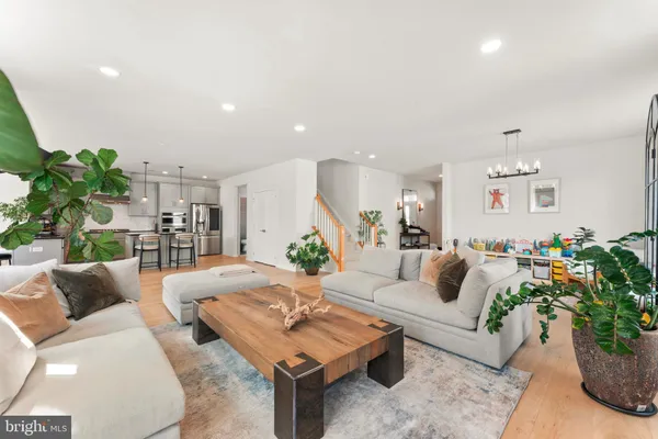 a kitchen with stainless steel appliances kitchen island granite countertop a refrigerator and a stove top oven