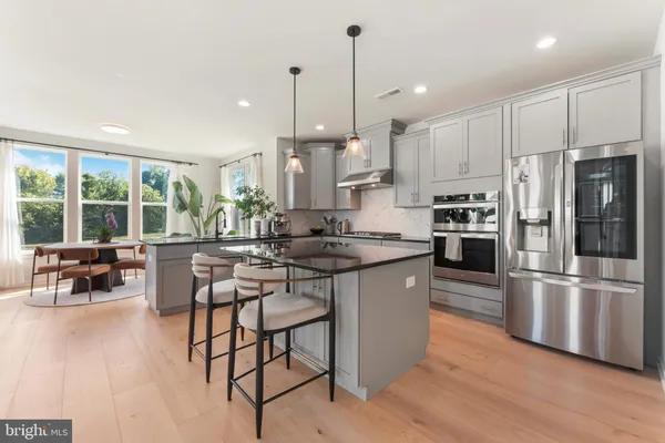 a kitchen with granite countertop a refrigerator and a sink