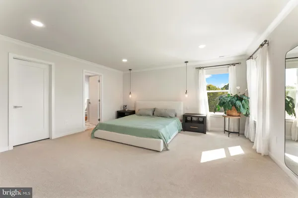 a large bedroom with a bed and a television