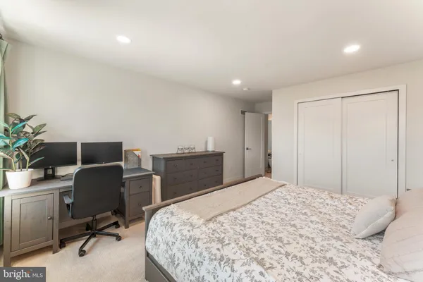 a spacious bedroom with a bed and a couch