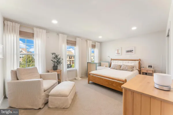 a bedroom with a large bed and a couch