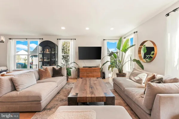 a living room with furniture a rug and a flat screen tv