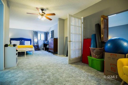 415 Tepatitlan Court Ridgecrest, CA 93555 - Photo 13 of 33 a living room with furniture and a flat screen tv