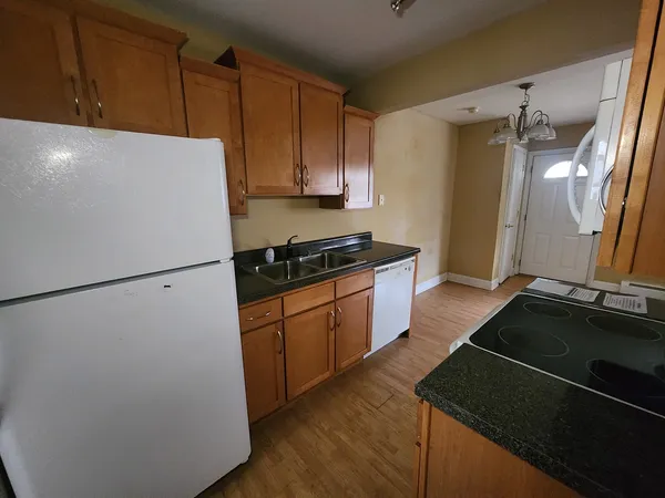 a kitchen with a refrigerator and a stove