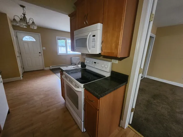 a kitchen with a sink stove and cabinets