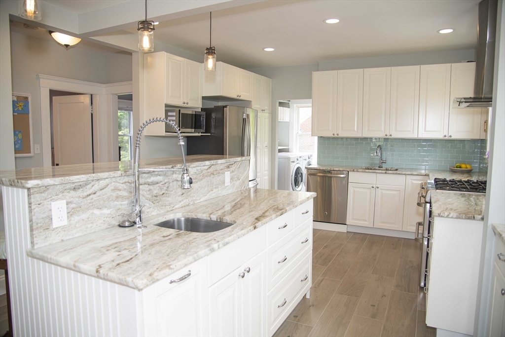 3 Chester Road, Unit 3 Belmont, MA 02478 - Photo 3 of 40 a kitchen with kitchen island granite countertop a sink counter top space appliances and cabinets