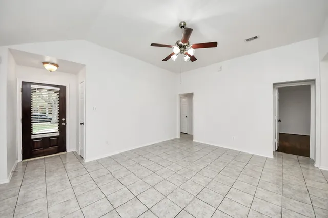 a view of a livingroom with a ceiling fan and window