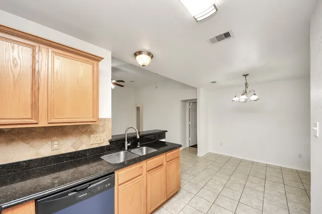a kitchen with granite countertop a sink and a stove