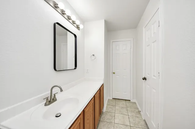 a bathroom with a double vanity sink and a mirror