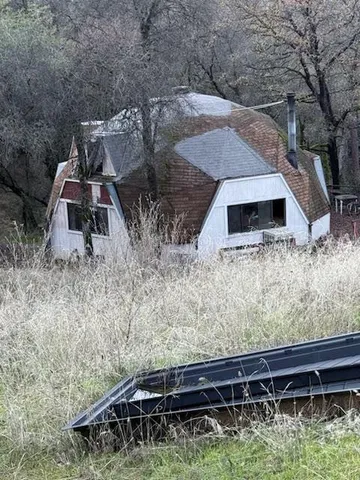 a view of backyard with wooden deck and seating space