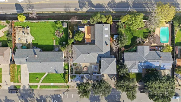 an aerial view of a house with a yard and potted plants