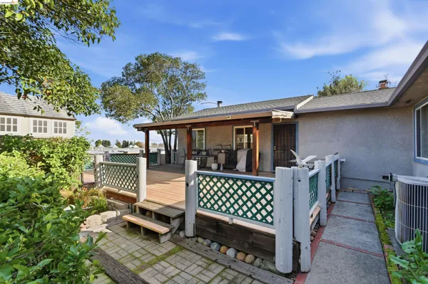 a view of a deck with furniture and a yard