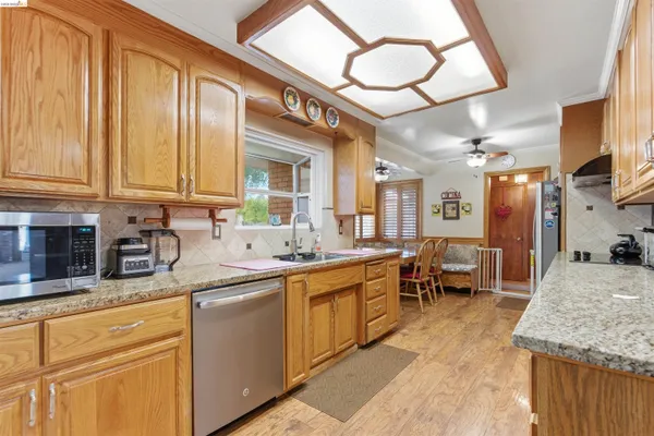 a kitchen with stainless steel appliances granite countertop a sink and cabinets