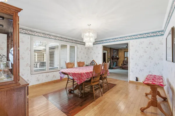 a dining room with furniture and window