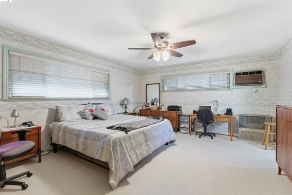 a bedroom with a bed and a chair