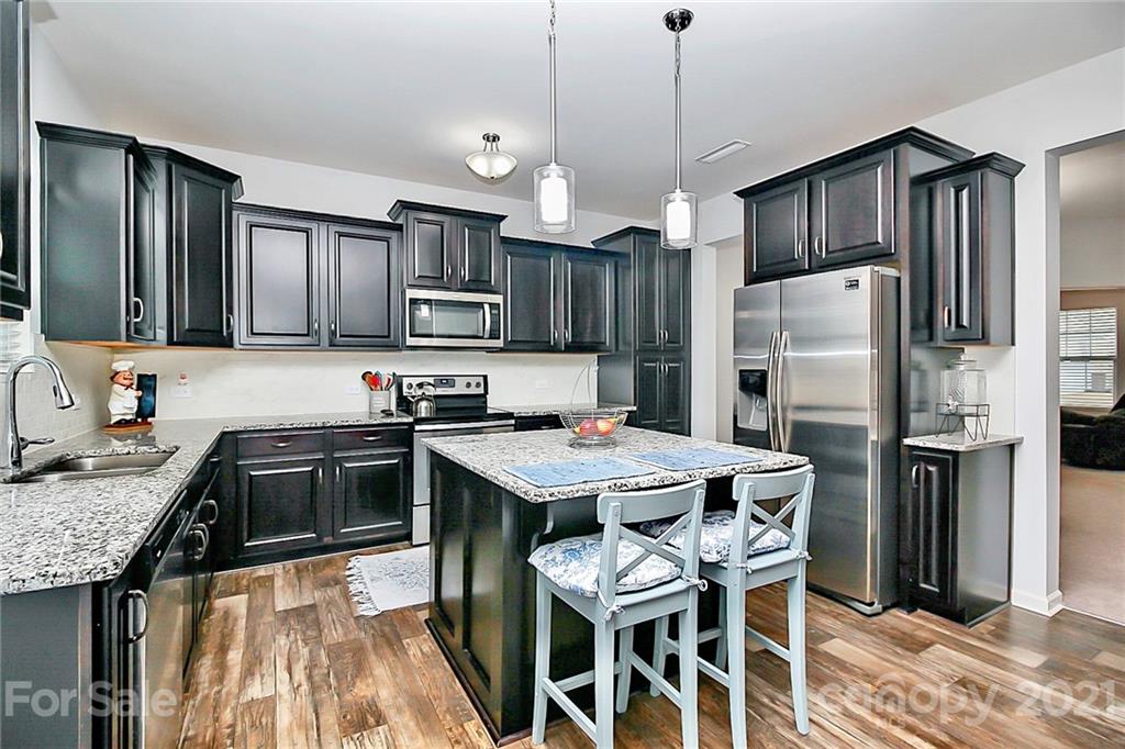 3034 Riker Street Clover, SC 29710 - Photo 13 of 42 a kitchen with stainless steel appliances granite countertop a stove a refrigerator a sink a stove and island
