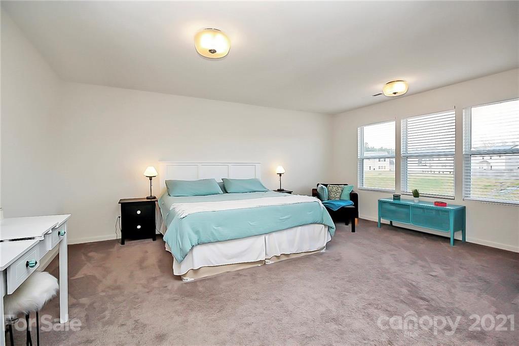 3034 Riker Street Clover, SC 29710 - Photo 25 of 42 a bedroom with a bed and a table lamp
