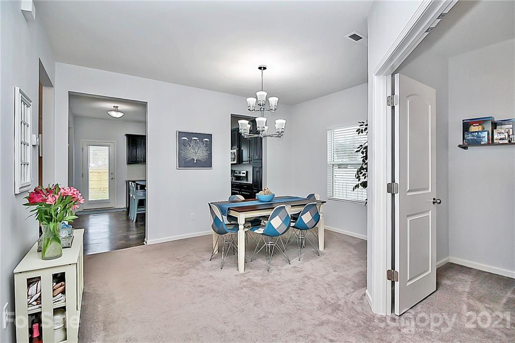 3034 Riker Street Clover, SC 29710 - Photo 6 of 42 a dining room with furniture potted plants and wooden floor