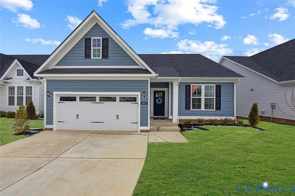 a kitchen with stainless steel appliances kitchen island granite countertop a sink a stove a dining table and chairs