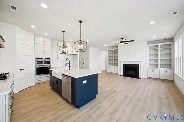 a view of kitchen with sink microwave and stove