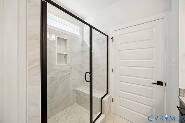 a bathroom with a shower and a glass door