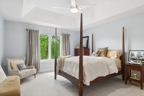 a bedroom with a bed couch and window