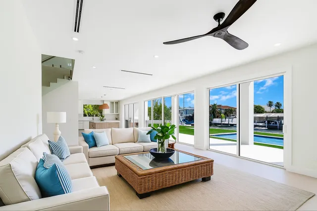 a view of a swimming pool with couches and lounge chairs