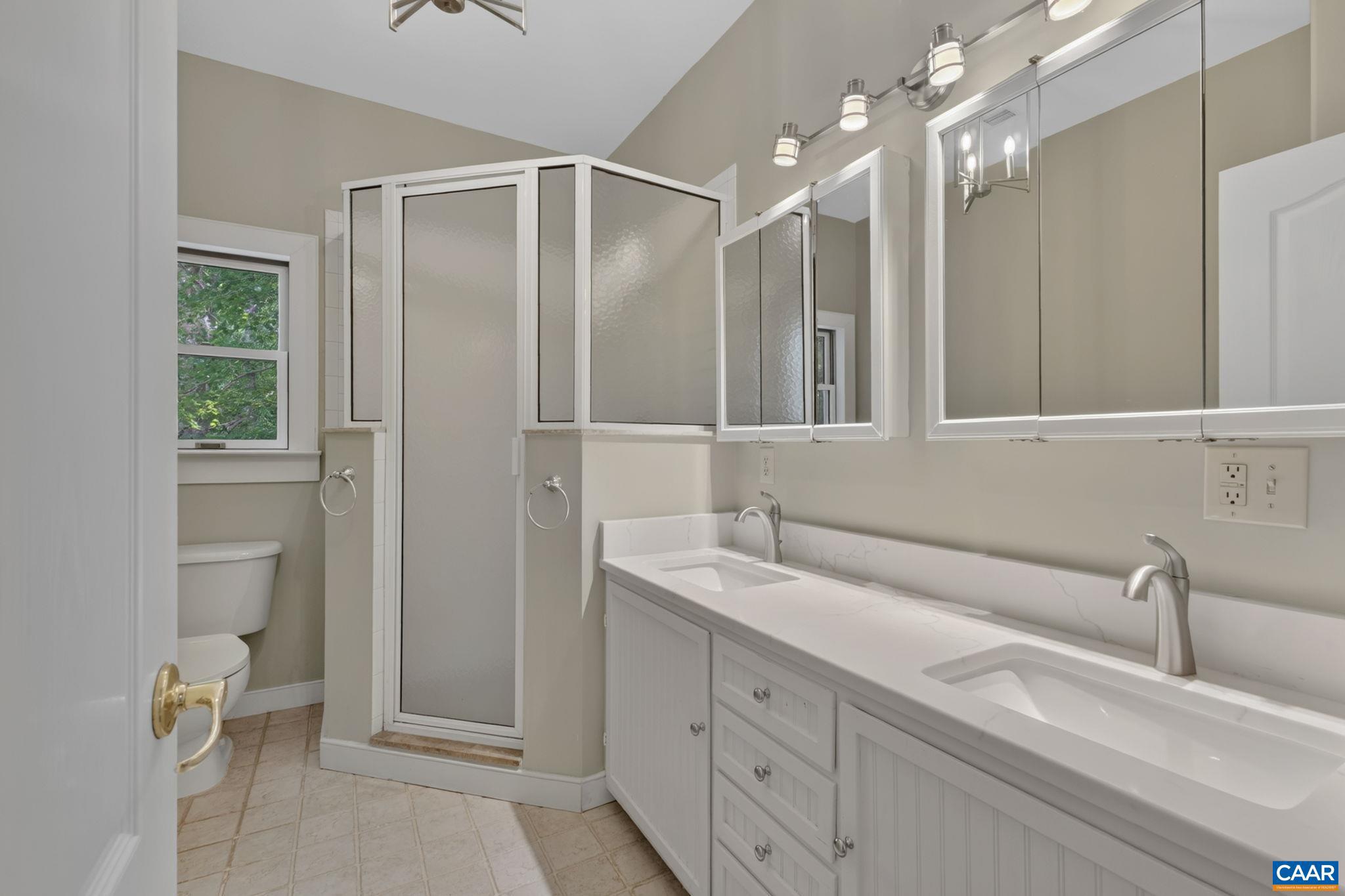 6285 Jarmans Gap Road Crozet, VA 22932 - Photo 25 of 65 a bathroom with a double vanity sink mirror and toilet