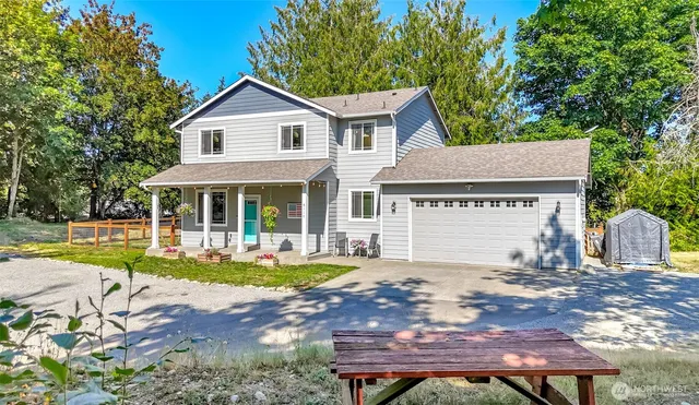 a front view of a house with a yard table and chairs