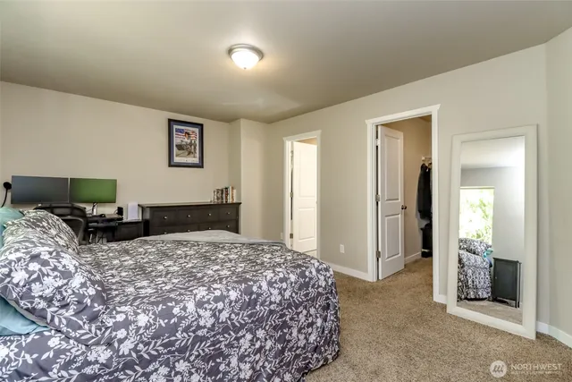 a bedroom with a bed and a television