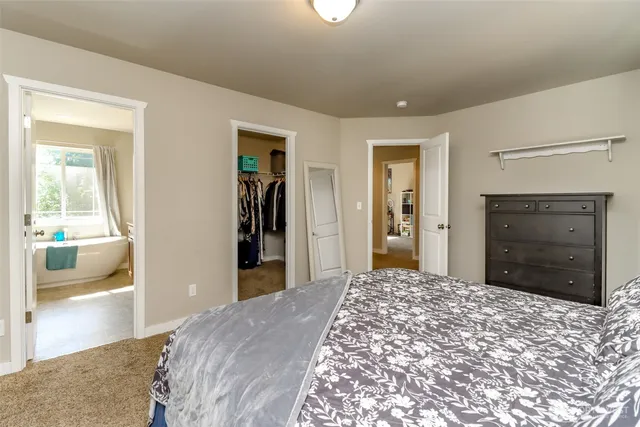 a bedroom with a bed and a view of bathroom