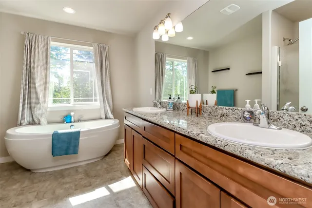 a spacious bathroom with sinks double vanity and a bathtub