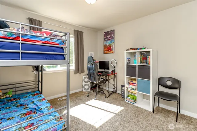 a living room with a baby crib and a wooden floor