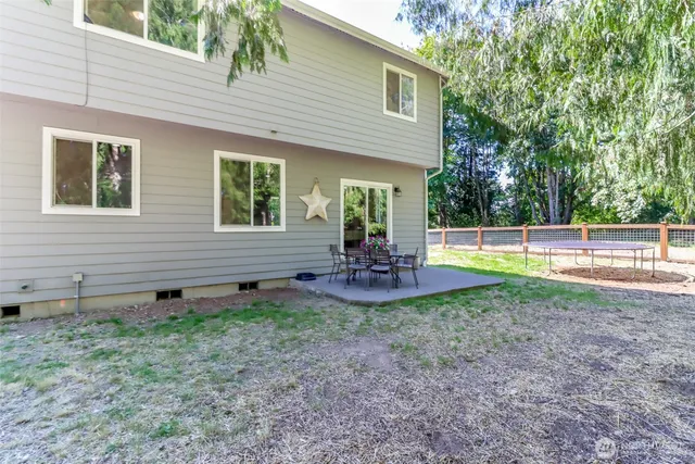 a view of a patio with table and chairs and potted plants