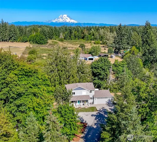 an aerial view of residential houses with outdoor space and street view