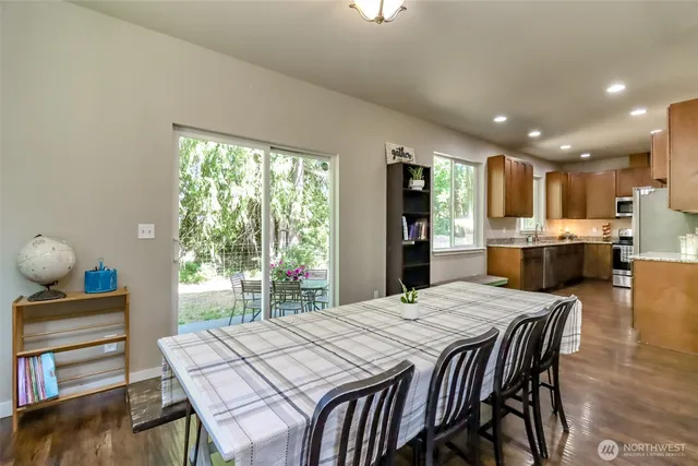 a view of a dining room with furniture and wooden floor