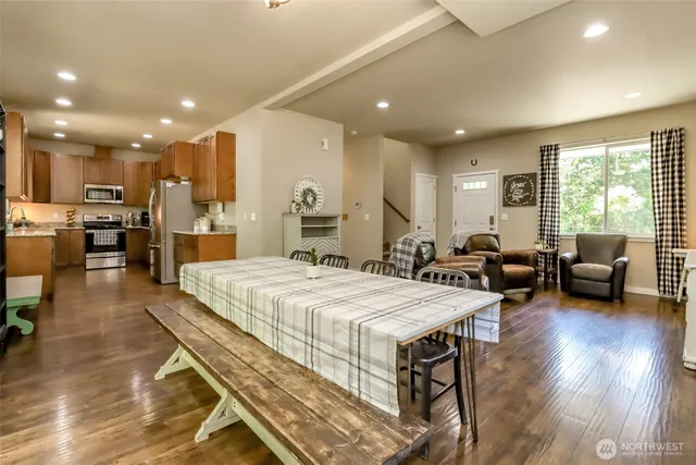 a large bedroom with kitchen island a large island a stove a table and chairs in it